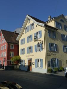 a white building on the side of a street at Hotel Lowen in Walenstadt