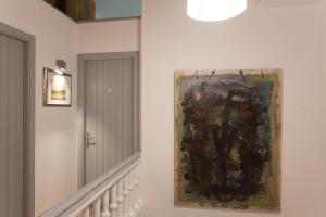 a painting hanging on a wall next to a staircase at Gran H La Marina in Altea