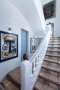 a staircase in a home with art on the walls at Gran H La Marina in Altea