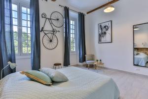 a bedroom with a bed with a bike hanging on the wall at MY CASA GARIBALDI - 4 bedrooms apartment in Nice