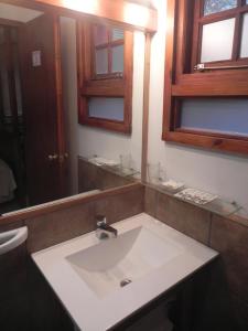 a bathroom with a white sink and a mirror at Mirando al Sur in San Carlos de Bariloche
