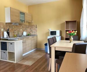 a kitchen with a table and a kitchen with a dining room at Apartment 20 Kamzík Donovaly in Donovaly