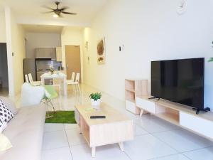 a living room with a large flat screen tv at No.5 The Mint @ Puchong center near IOI Mall in Puchong