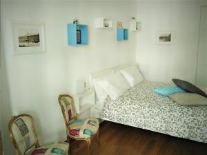 a bedroom with a bed and two chairs at I Reali Bed & Breakfast in Turin