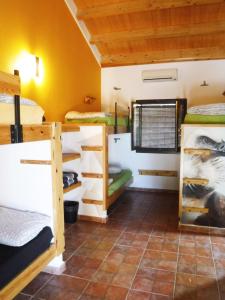 a room with a group of bunk beds at Tantaka - Albergue Los Meleses in Radiquero