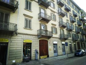 un edificio con balcones y un coche aparcado delante de él en I Reali Bed & Breakfast en Turín