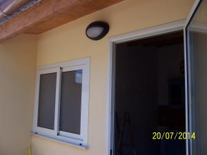 a light on a wall next to a sliding glass door at Ni La Za Ciccina in Castellammare del Golfo