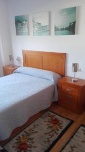 イスラ・デ・アローサにあるApartamento As Laxes de Illa de Arousaのベッドルーム1室(大型ベッド1台、ナイトスタンド2台付)