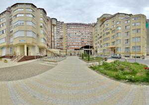 a walkway in front of some tall buildings at Apartment OneClickRent_04 - Smart House in Chişinău