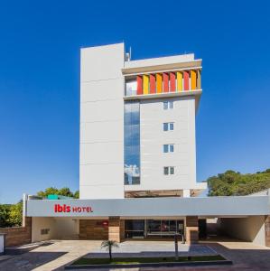 a white building with colorful windows on it at ibis Erechim in Erechim