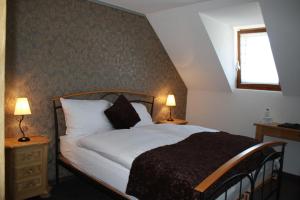En eller flere senge i et værelse på Hotel de la Gare