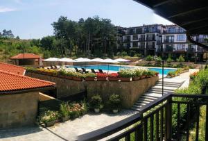 a view of a swimming pool with chairs and plants at Limani Guest house in Sozopol