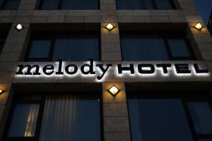 a melley hotel sign on the side of a building at Melody Hotel - an Atlas Boutique Hotel in Tel Aviv