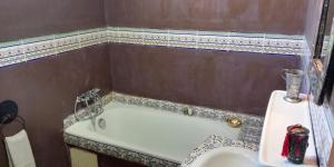 a bathroom with a sink and a bath tub at Villa du Souss in Agadir