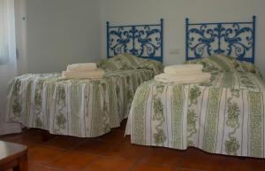 two beds in a room with towels on them at Villa Emilia in Ruidera +41 photos