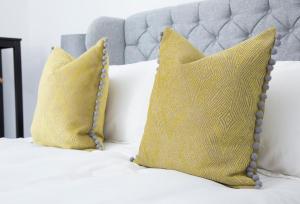 two yellow pillows are sitting on a bed at The Annex in Carlisle +37 photos