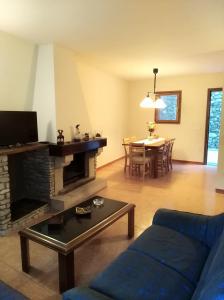 a living room with a blue couch and a table at CR TESOL 6 SON - ALT ANEU in Son