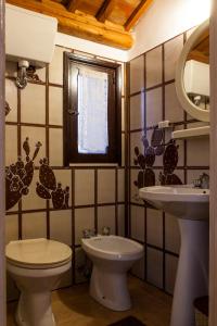 a bathroom with a toilet and a sink at Sogno Siciliano Turismo Rurale in Erice