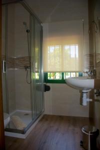 a bathroom with a glass shower and a sink at Villa Emilia in Ruidera