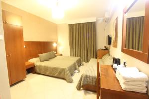 Postel nebo postele na pokoji v ubytování Hotel Mallas