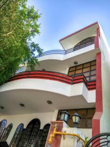 a house with a red and white facade at The Desire Hostel in New Delhi