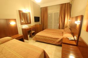Postel nebo postele na pokoji v ubytování Hotel Mallas