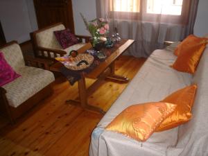 a living room with two couches and a table at Traditional House Paschalis in Kavala