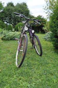 a bike parked in the grass in a yard at Paloznak Retrospektív in Paloznak