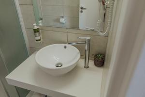a bathroom with a white sink on a counter at River View Boutique Apts in Ayia Napa