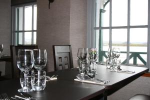 a table with wine glasses sitting on top of it at North Kessock Hotel in Inverness