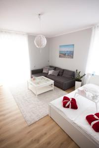 a living room with two beds and a couch at Studio Morski Klimat in Władysławowo