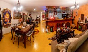 a living room with a couch and a table and chairs at Kabatukila Pousada in Natal
