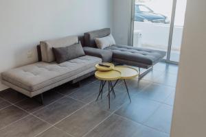 a living room with a couch and a table at River View Boutique Apts in Ayia Napa