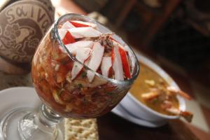 a glass cup filled with food and a bowl of soup at Hotel Salvador Gaviota in Lívingston