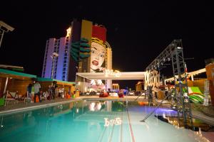 a swimming pool in front of a building at night at Plaza Hotel & Casino in Las Vegas