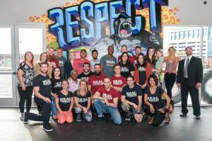 a group of people posing for a picture in front of a mural at Plaza Hotel & Casino in Las Vegas