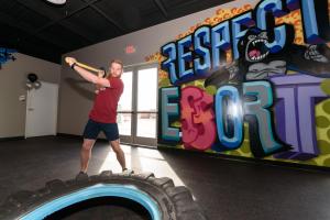 a man standing on a giant tire in a gym at Plaza Hotel & Casino in Las Vegas