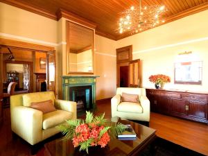 a living room with two chairs and a fireplace at Falcons View Manor in Knysna
