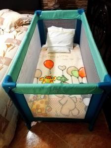 a crib with a bed frame with a bedsheet with mushrooms at House Joel & Sónia in Funchal