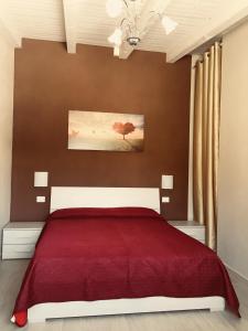 1 dormitorio con 1 cama con manta roja en Casa Alice, en Siracusa