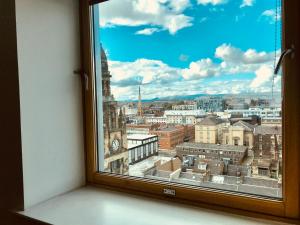 a window with a view of a city at Glasgow Central Station SKYLINE Apartment with Parking (2 bedrooms, 2 bathrooms, 1 living room-Kitchen) in Glasgow
