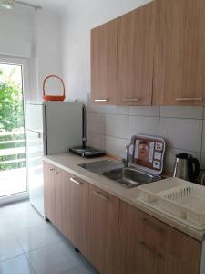 a kitchen with a sink and a refrigerator at Mario's Apartment in Neos Marmaras