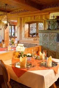 a dining room with a table with wine glasses at Landhotel Huberhof in Schwangau