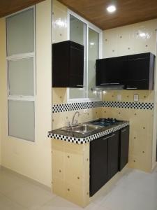 a kitchen with a sink and a counter top at Hotel Zafiro in Leticia