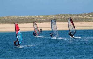 a group of people windsurfing in the ocean at Alfamiano in Alfarim