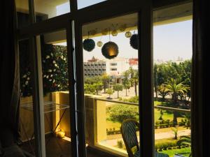 a window with a view of a city at CosyFlat 10minBeach in Agadir