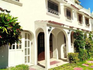 Biały dom z łukiem i drzwiami w obiekcie Casa Blanca Boutique & Organic w mieście Cancún