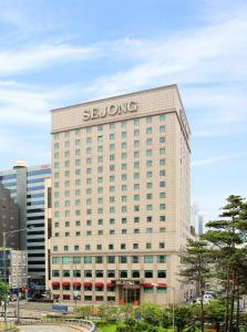 a building with the sbuong sign on top of it at Sejong Hotel Seoul Myeongdong in Seoul