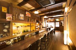 a bar in a restaurant with a row of bar stools at Kinsuikan in Miyajima +192 photos
