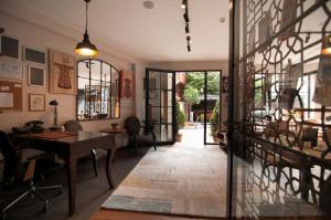 a hallway with a table and a desk in a room at Nomade Hotel Exclusive in Istanbul